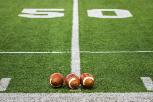 3-footballs-on-field-https://unsplash.com/photos/three-footballs-sitting-on-a-football-field-lS8imu0yCKw